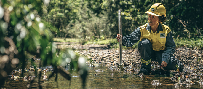 Employee performing monthly water testing in Yabba Creek near Imbil